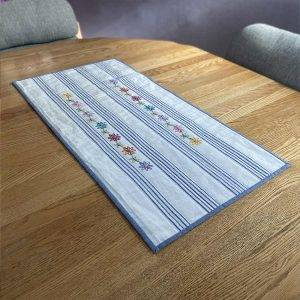 Embroidered daisies table runner on a dining room table