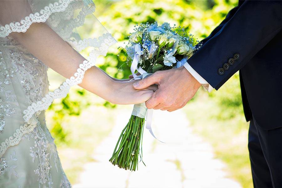Closeup of the hands of a couple getting married