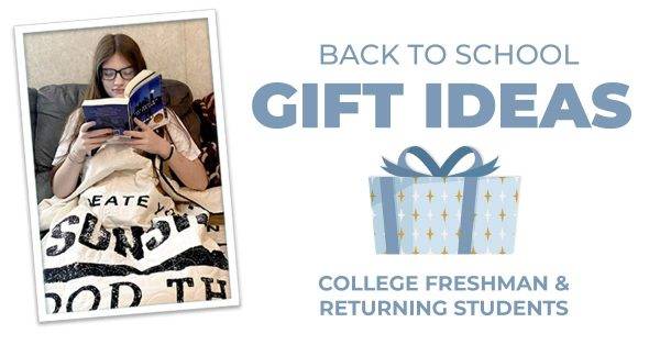 College student reading a book wrapped in a throw quilt blanket