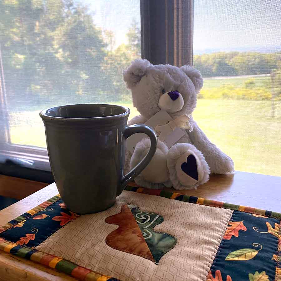 Autumn themed leaf mug rug with a coffee cup in the livingroom