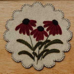 Meadow Trio Wool Mat 8 in diameter beige background with red cone flowers and green stems and leaves