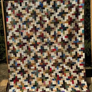 Floating Pinwheels Quilt multiple colored scraps of fabric quilted together in a pinwheel design