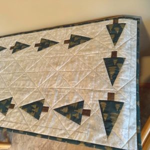 "Trees All Around" Table Runner 18 x 47, tan squares with white snowflakes with green and gold triangle trees with brown trunks