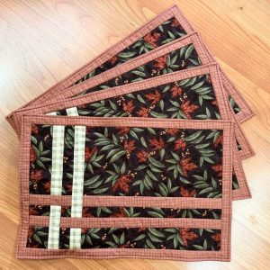 "Criss Cross Leaves" Placemats 13 x 19 set of 4, red and green leaves on black background with yellow berries