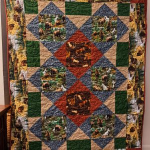 "Snuggle with the Wilds" Couch Quilt 51 X 68 green, tan, orange, blue, red, brown, with bears, moose, and elk